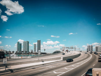 City street and modern buildings against sky