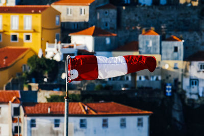 Multi colored flags hanging on buildings in town