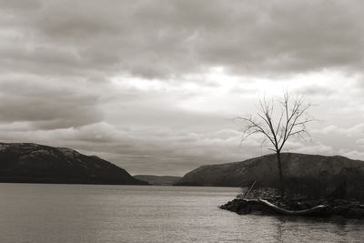 Scenic view of lake against cloudy sky