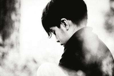 Close-up portrait of young man looking away