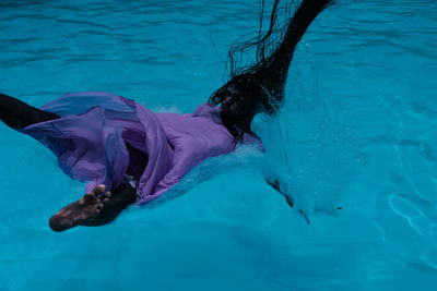 Woman falling in swimming pool
