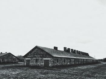 Abandoned house on field against sky