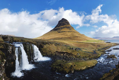 Scenic view of waterfall against sky