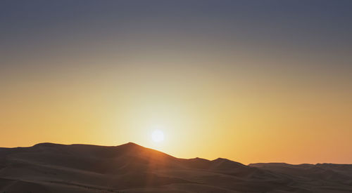 Scenic view of mountains against sky during sunset