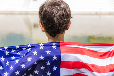 Boy with american flag in city