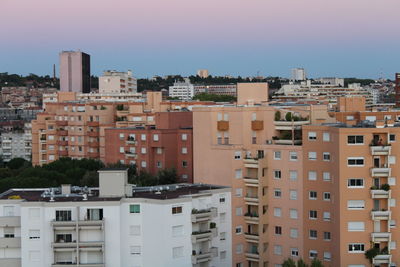 Buildings in city against clear sky