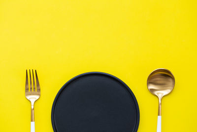 Directly above shot of yellow and spoon on table
