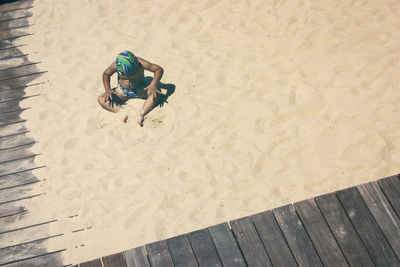 High angle view of child on sand