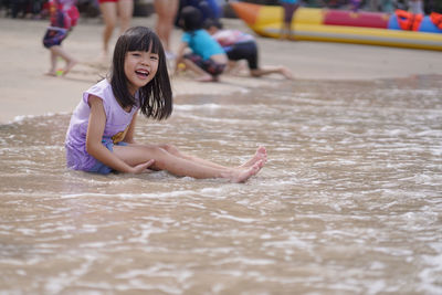 Full length of cute girl enjoying in water