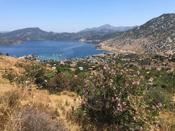 Scenic view of sea and mountains against clear sky