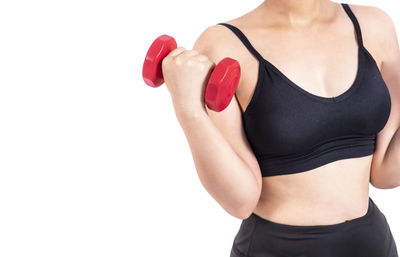 Midsection of woman standing against white background