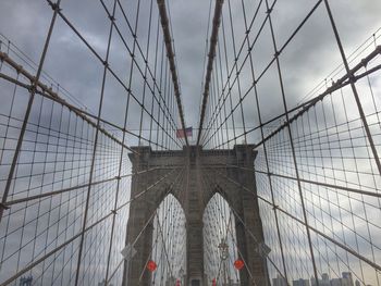 Low angle view of brooklyn bridge against sky in city