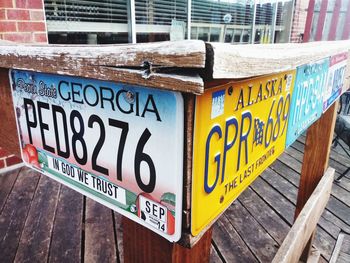 Close-up of information sign on wood in city