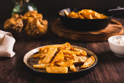 Pieces of celery root fried with paprika on a plate on the table