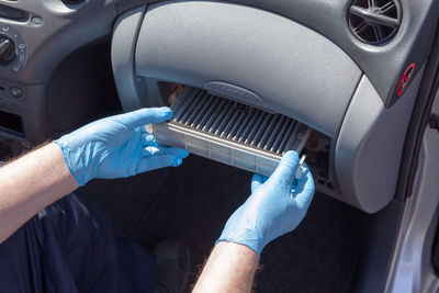 Midsection of man repairing car