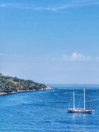 Sailboat sailing in sea against sky