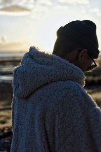 Close-up of boy standing on snow covered beach