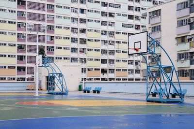 Basketball court against buildings in city