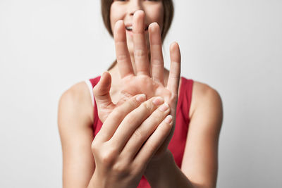 Cropped image of woman hand against white background