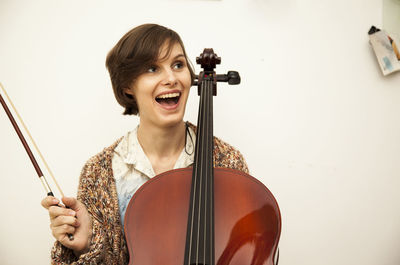 Cheerful woman playing violin