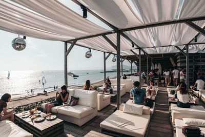 People sitting at restaurant during sunny day