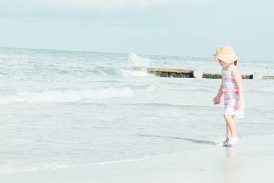 Man standing on beach against sky