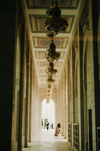 People walking in corridor of building