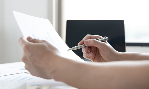 Close-up of man holding paper