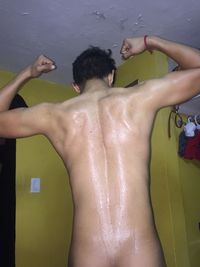 Rear view of shirtless man in water