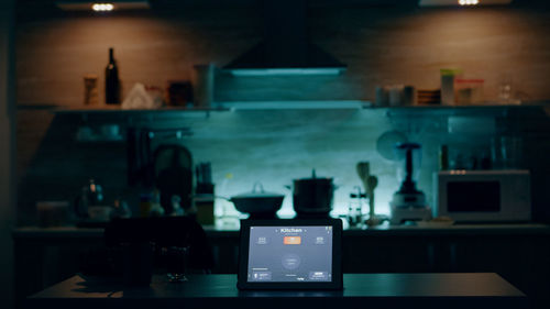 Close-up of illuminated lighting equipment on table at home