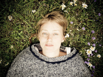 Portrait of young woman lying on grass