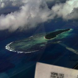 Aerial view of sea against cloudy sky