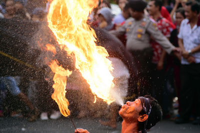 Fire-eater performing on street