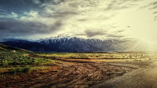 Scenic view of mountains against cloudy sky