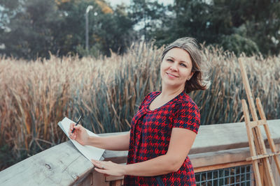 Woman standing by railing