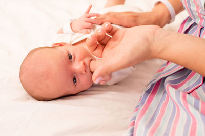 Close-up of baby boy sleeping on bed at home