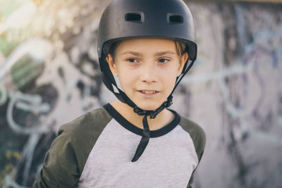 Boy wearing crash helmet outdoors