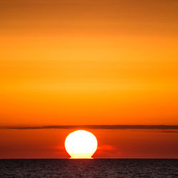 Scenic view of sea against orange sky