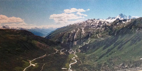 Scenic view of mountains against cloudy sky