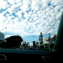 City street and buildings against sky