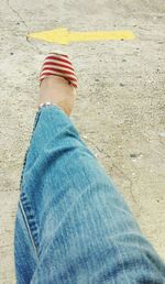 Low section of woman standing on tiled floor