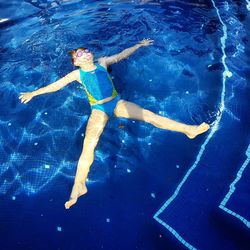 High angle view of woman swimming in pool