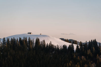 Snow covered mountain against sky during sunset