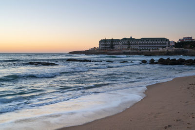 Ericeira vila gale hotel at sunset with baleia beach in portugal