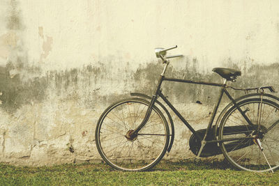 Bicycle leaning on wall