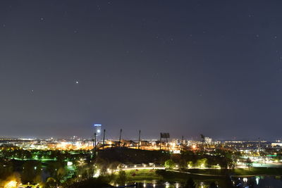 High angle view of illuminated buildings against sky at night