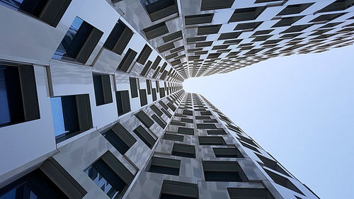 Directly below shot of buildings against clear sky