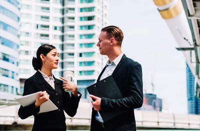 Man standing in front of office building