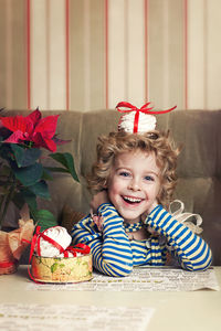 Portrait of smiling girl sitting at home