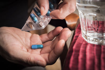 Close-up of hands holding glass